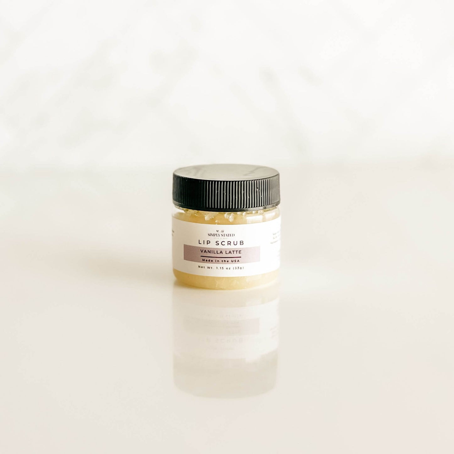 Simply Stated vanilla latte lip scrub in a pale beige tone, reminiscent of creamy vanilla coffee, perfect for gentle lip care.