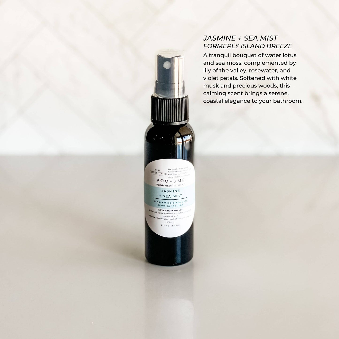 Bottle of Jasmine & Sea Mist poofume bathroom spray on a white background with product description text.