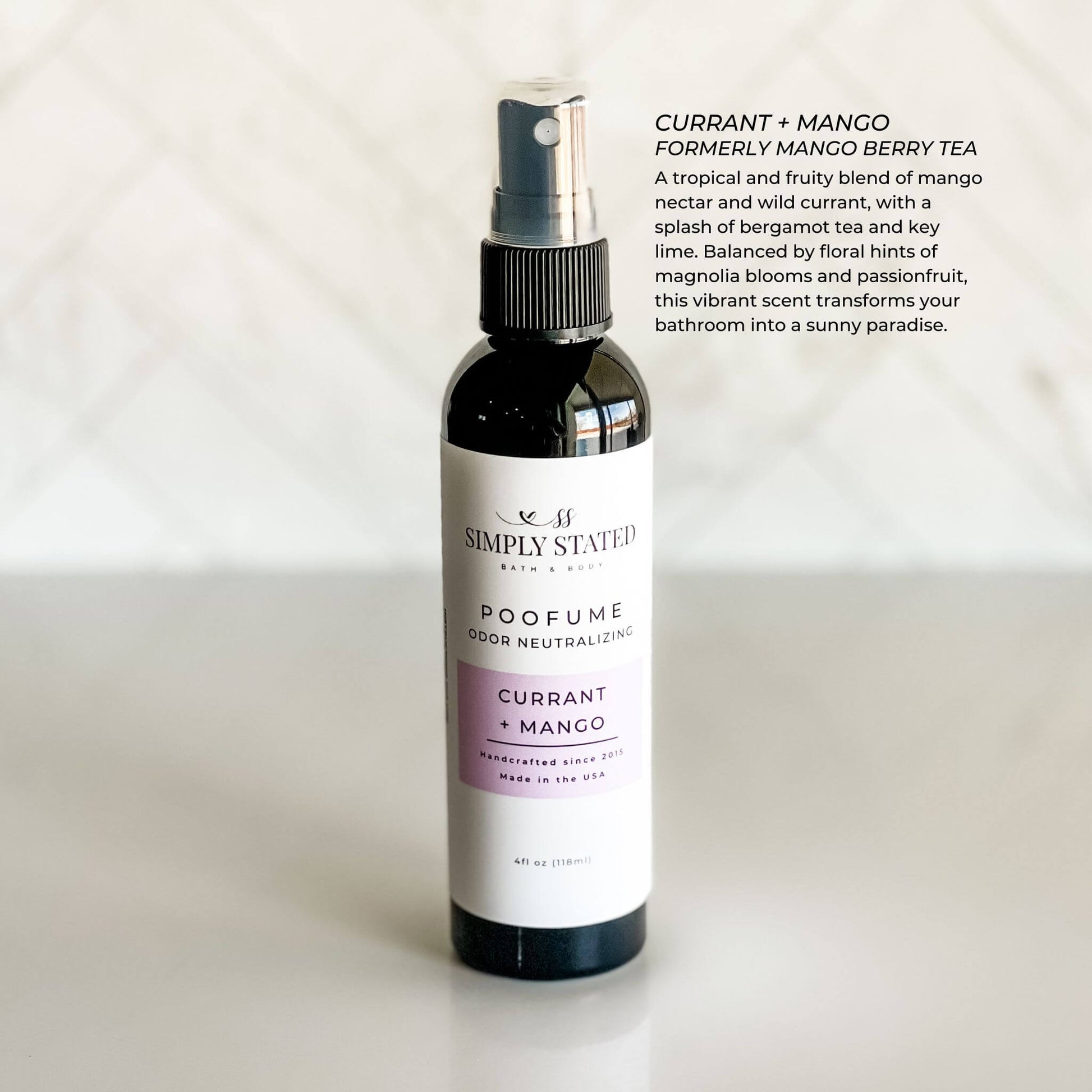 Bottle of Simply Stated 'Currant + Mango' poofume on a white background