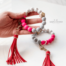 Bangle Keychain made with silicone beads in rose pink, grey, and white marble. Tassle included