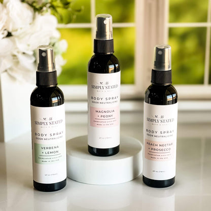 Spring Floral Orchard Collection Body Spray trio displayed with Magnolia + Peony, Peach Nectar + Prosecco, and Verbena + Lemon variants in a lush spring background.