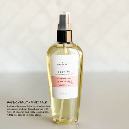 Simply Stated Bath & Body Passionfruit + Pineapple Body Oil bottle on a white background. A summer-inspired blend with notes of juicy passionfruit, tart pineapple, mango, coconut, and lemongrass. Includes camellia seed oil for soft, glowing skin.