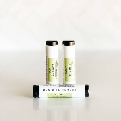 Three Fight the Bite Bug Bite Remedy Sticks shown upright on white surface, natural bug bite relief in twist-up tube.
