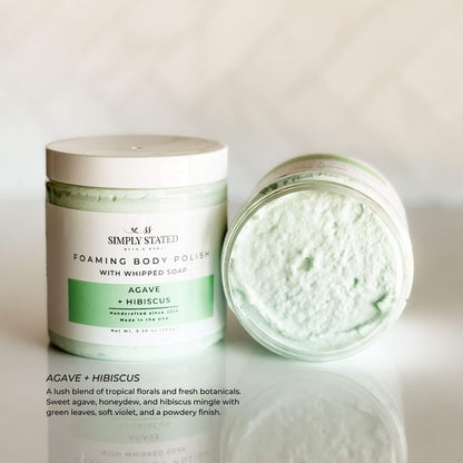 Simply Stated Foaming Body Polish in Agave + Hibiscus – light green whipped sugar scrub with a tropical floral scent and smooth, airy texture, shown in an open jar.