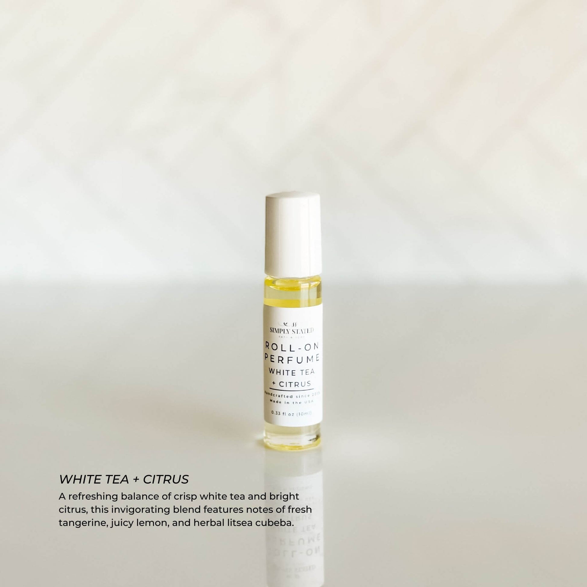 Simply Stated Roll-On Perfume in White Tea + Citrus – clean and citrusy fragrance with tangerine, lemon, and litsea cubeba in a sleek glass bottle for everyday wear.