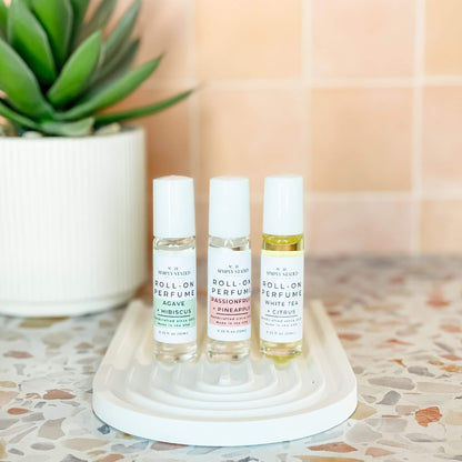 Summer Roll-On Perfume Trio by Simply Stated – Agave + Hibiscus, Passionfruit + Pineapple, and White Tea + Citrus scents displayed on ceramic tray with succulent.