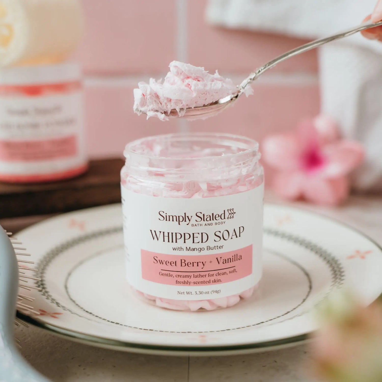 Sweet Berry + Vanilla Whipped Soap in an 8 oz jar with a spoon lifting a dollop of the whipped texture
