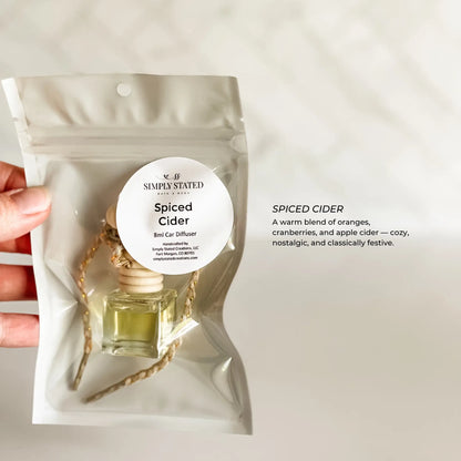 Spiced Cider diffuser packaging held by a hand on a light background