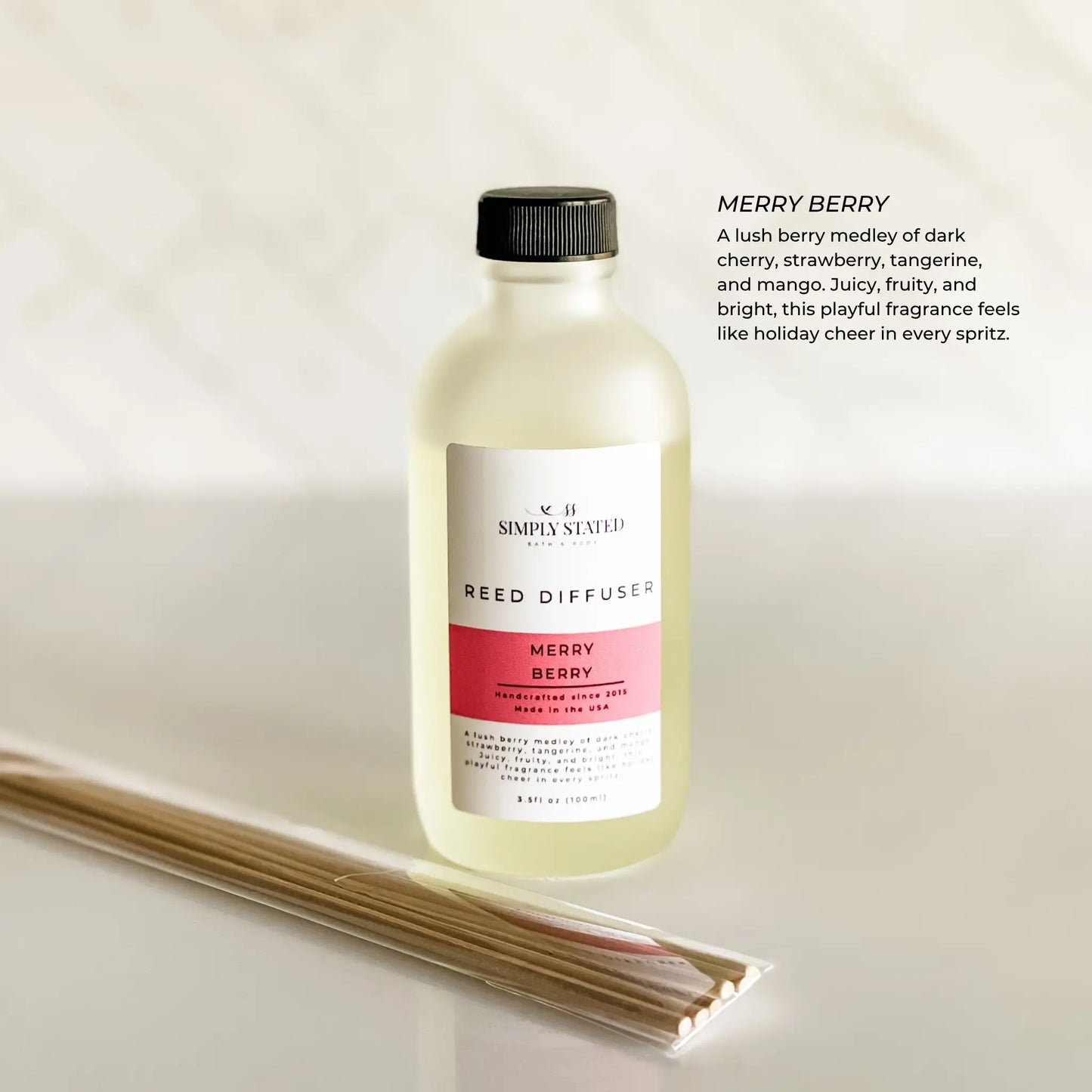 Reed diffuser bottle labeled 'Merry Berry' by Simply Scented on a light background