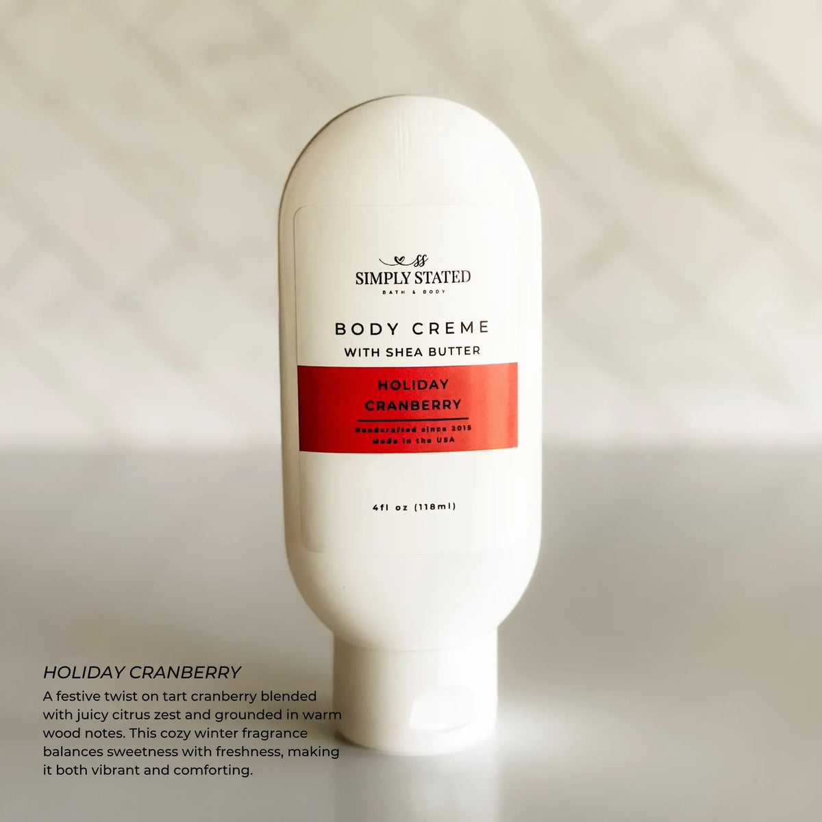 Simply Stated Holiday Cranberry Body Creme with shea butter, tart cranberry citrus scent, on marble background.