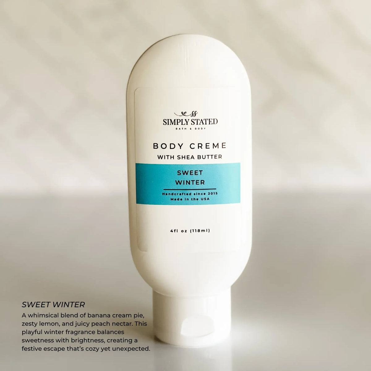 Simply Stated Sweet Winter Body Creme with shea butter, banana lemon peach scent, on marble background.