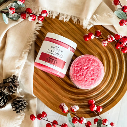 Simply Stated Holiday Cranberry Body Polish with kokum butter, pink sugar scrub styled with berries and pinecones.