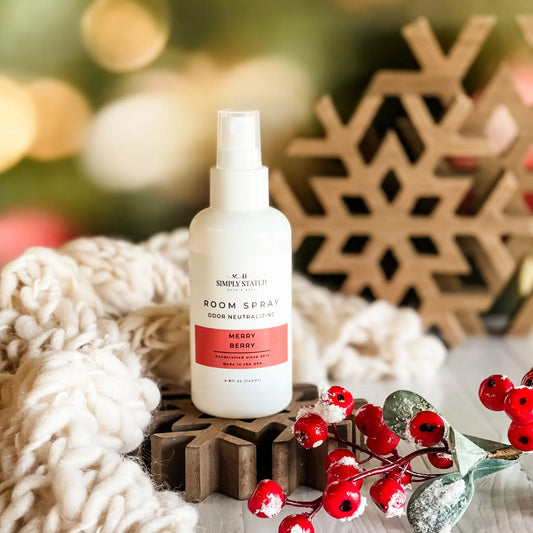 Simply Stated Merry Berry Room Spray, odor neutralizing, styled with a wooden snowflake, cozy knit, and red berries.