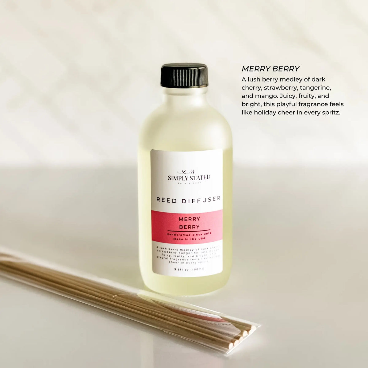 Simply Stated Merry Berry Reed Diffuser in frosted glass, cherry strawberry tangerine mango scent, with reeds on marble.