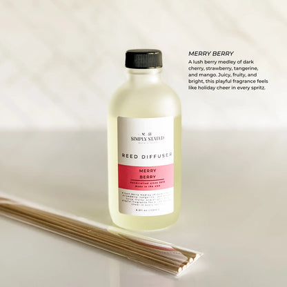 Simply Stated Merry Berry Reed Diffuser in frosted glass, cherry strawberry tangerine mango scent, with reeds on marble.
