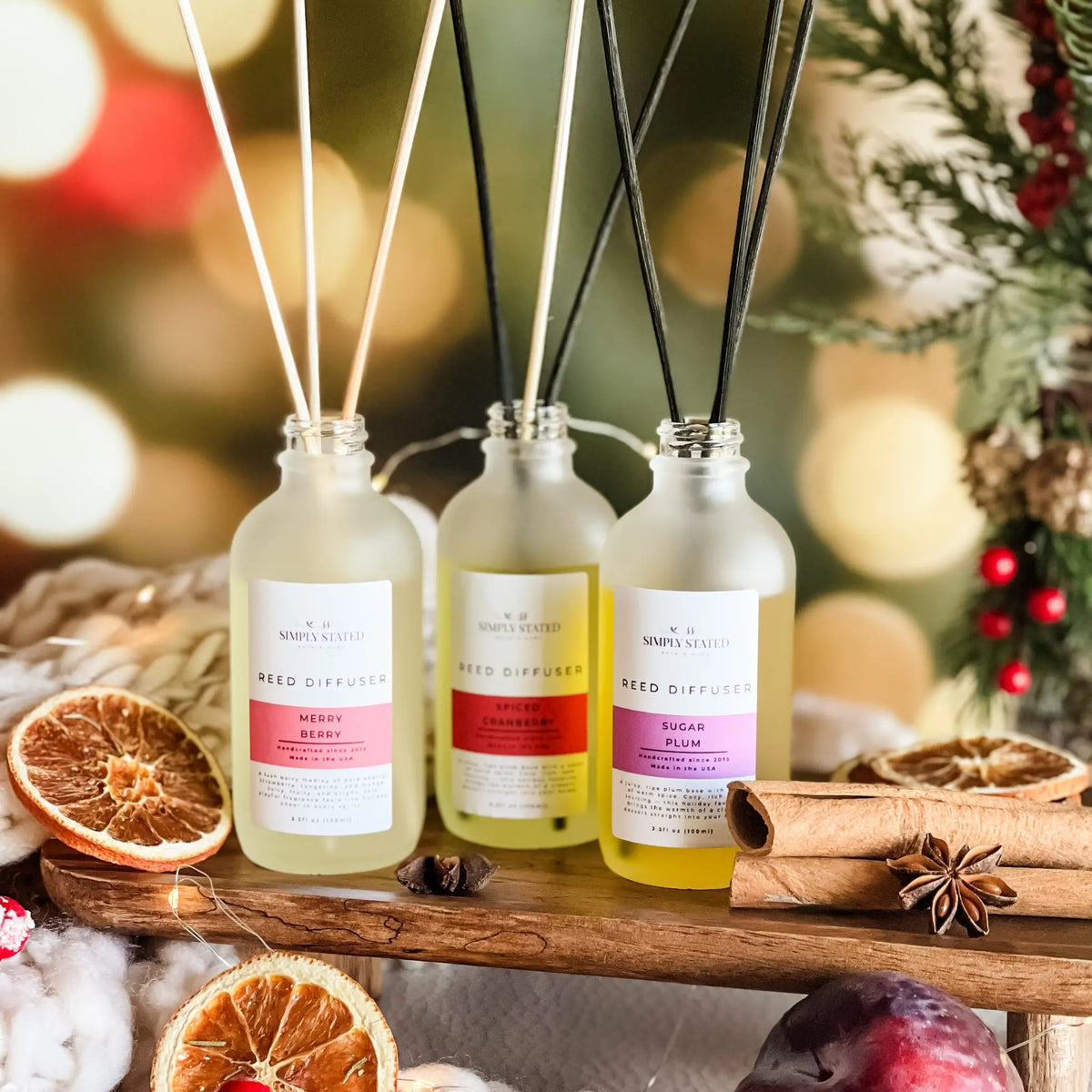 Simply Stated Reed Diffuser trio, Merry Berry, Spiced Cranberry, Sugar Plum, with dried oranges and cinnamon.