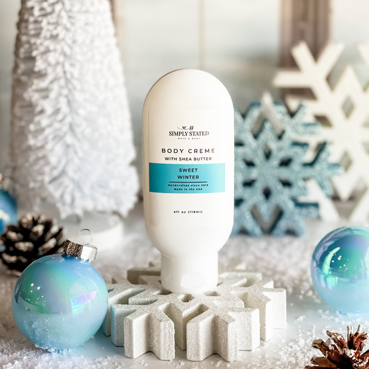 Simply Stated Sweet Winter Body Creme with shea butter, icy winter scene with snowflakes and blue ornaments.