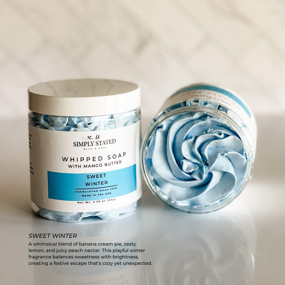 Simply Stated Sweet Winter Whipped Soap with mango butter, banana lemon peach scent, blue swirled lather on marble.